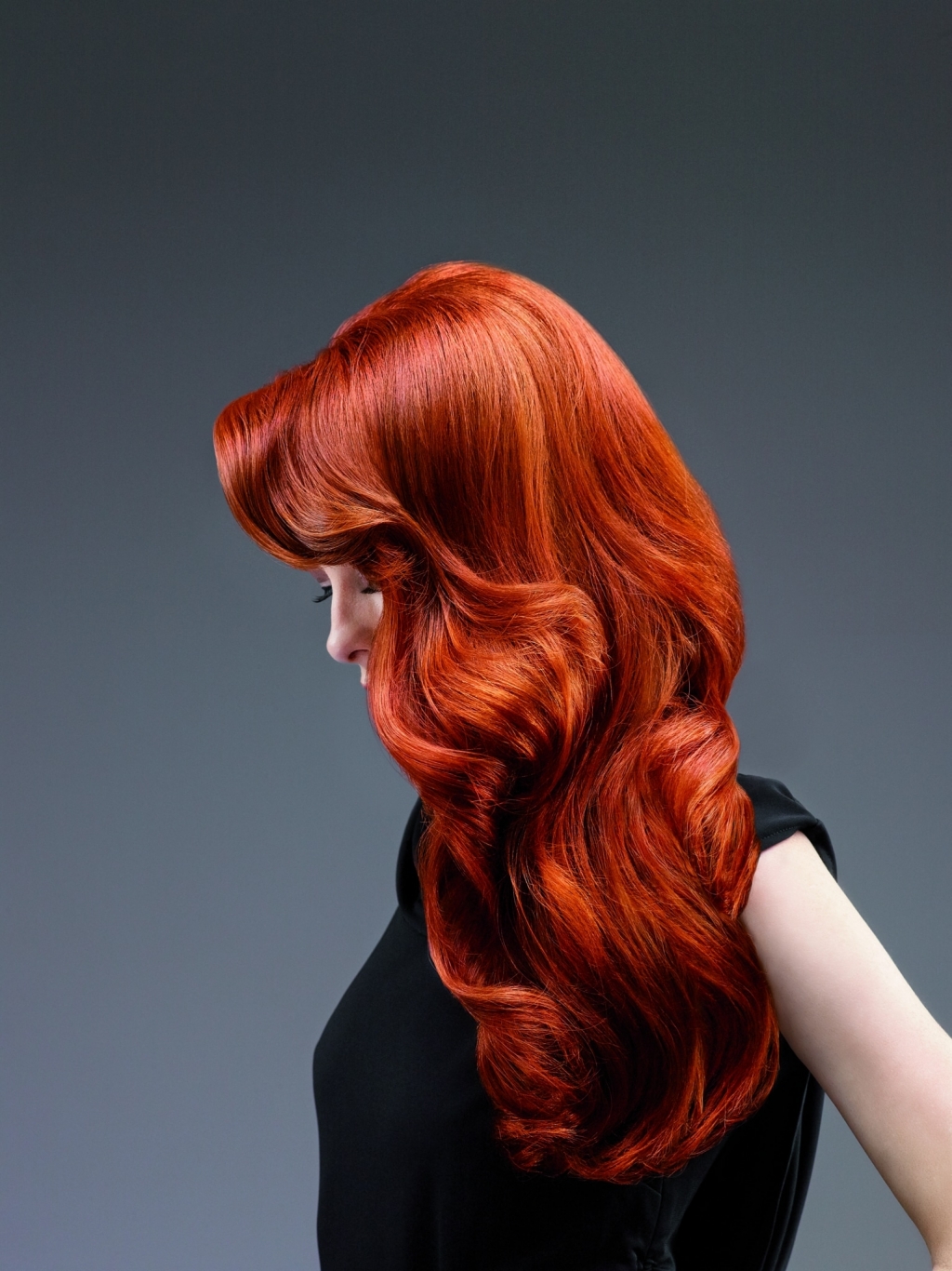 Woman with red hair with hair thickening in lengths and tips